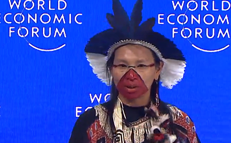 A shaman performs a pagan ritual over the leaders of the World Economic Forum at the Davos summit